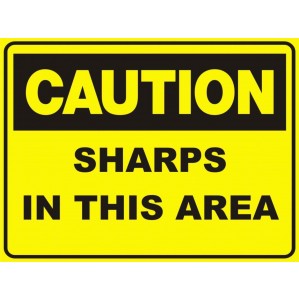 A yellow hazard warning sign with bold black text reading "signsofsafety CA44 Caution Sharps in this area." The sign has a black border and clear, visible lettering for safety warnings.