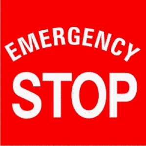 A bright red Signs of Safety Emergency Stop sign with bold white text reading "Emergency Stop" to indicate a safety or stop mechanism.